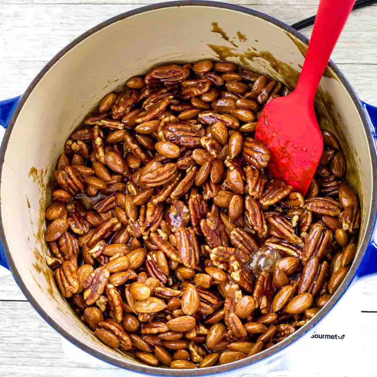 stirring pecans and almonds with a spatula