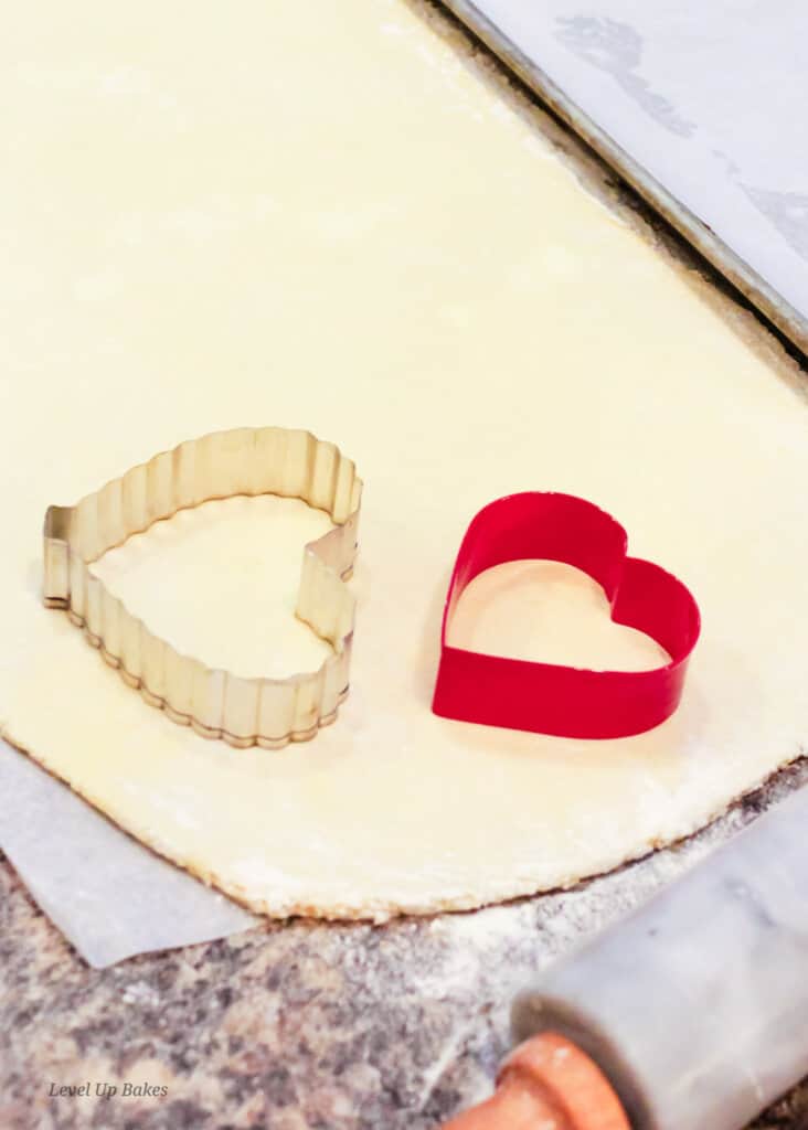 rolled out dough and heart cookie cutter