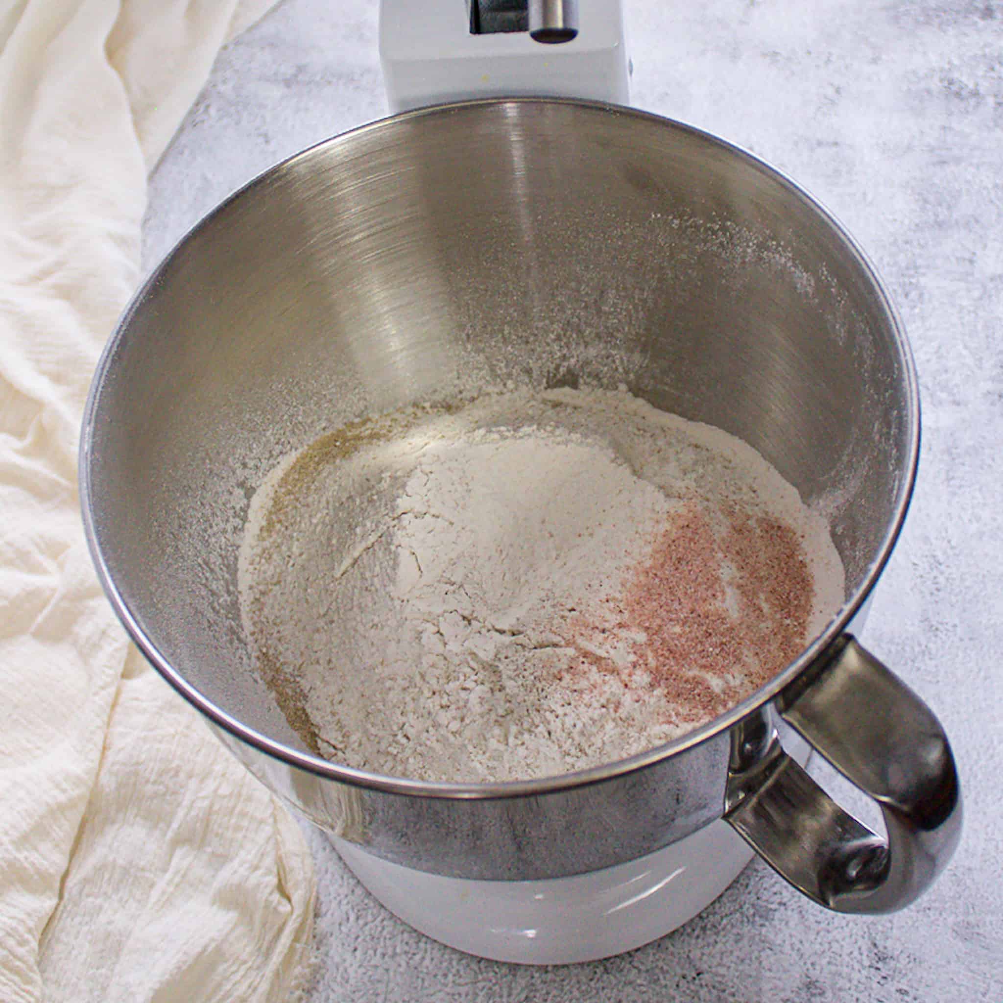flour, salt, yeast, sugar in stand mixer bowl