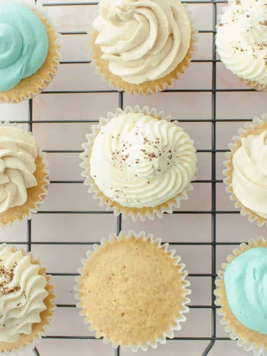 close up of 8 frosted cupcakes and 1 unfrosted