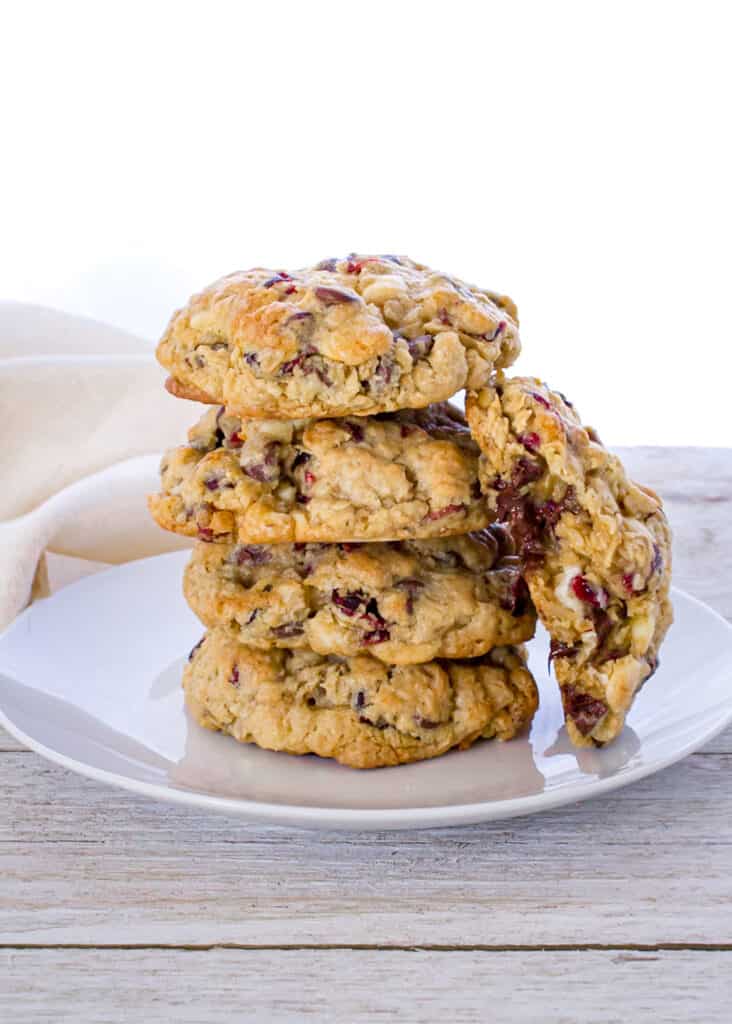 stack of 4 oatmeal cookies with one leaning against the stack