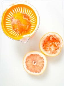 hand juicer and two grapefruit halves