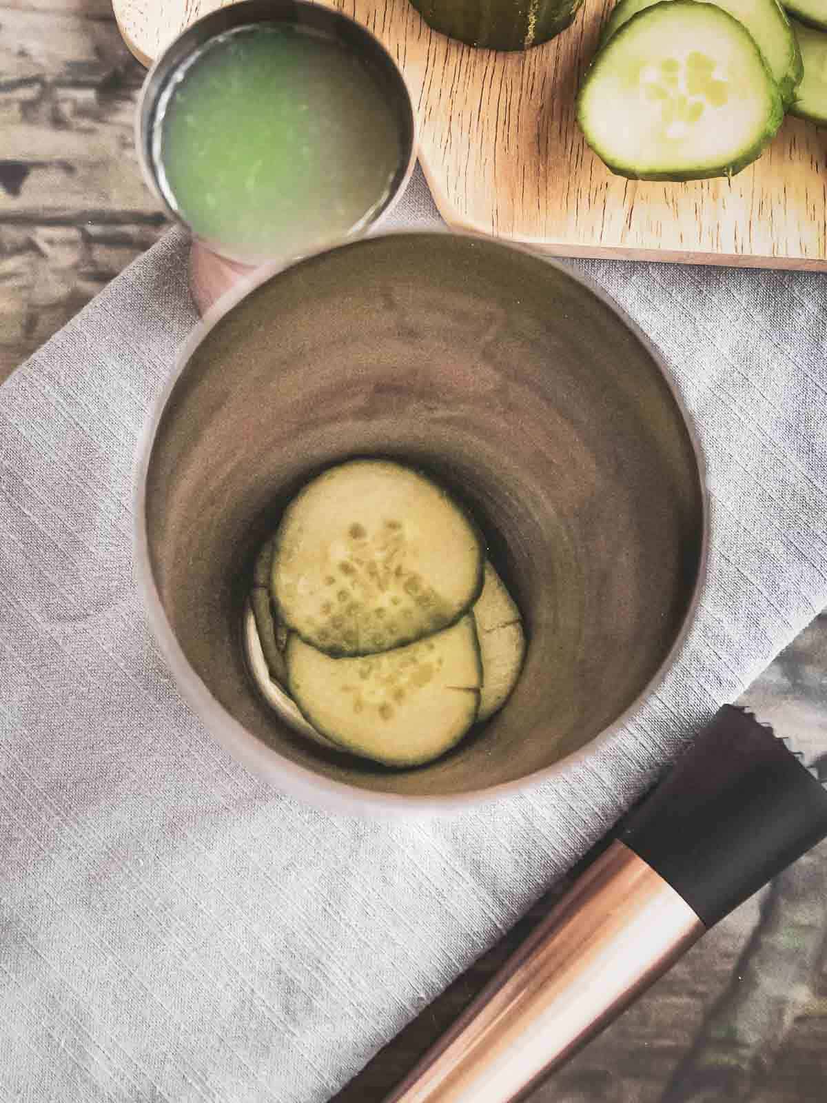 5-6 sliced cucumbers in the cocktail shaker
