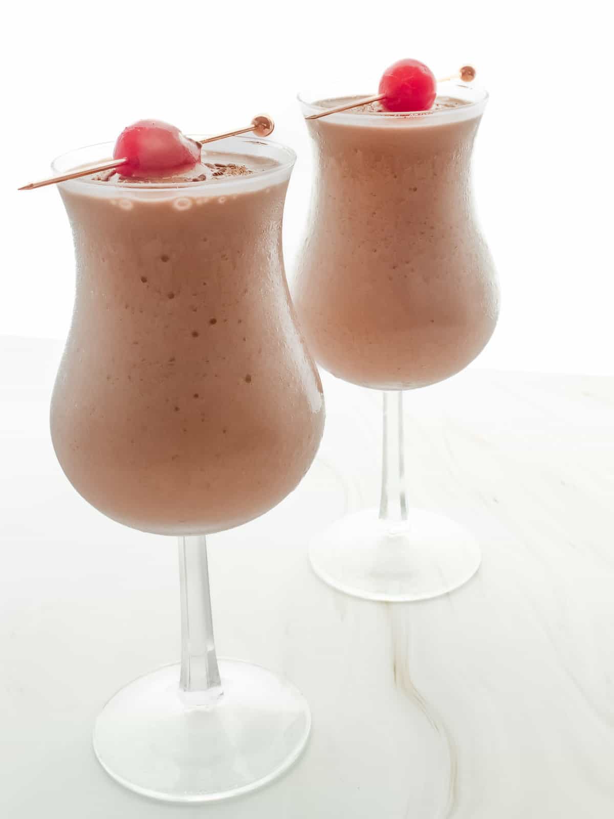 two mocktails with cherry garnish
