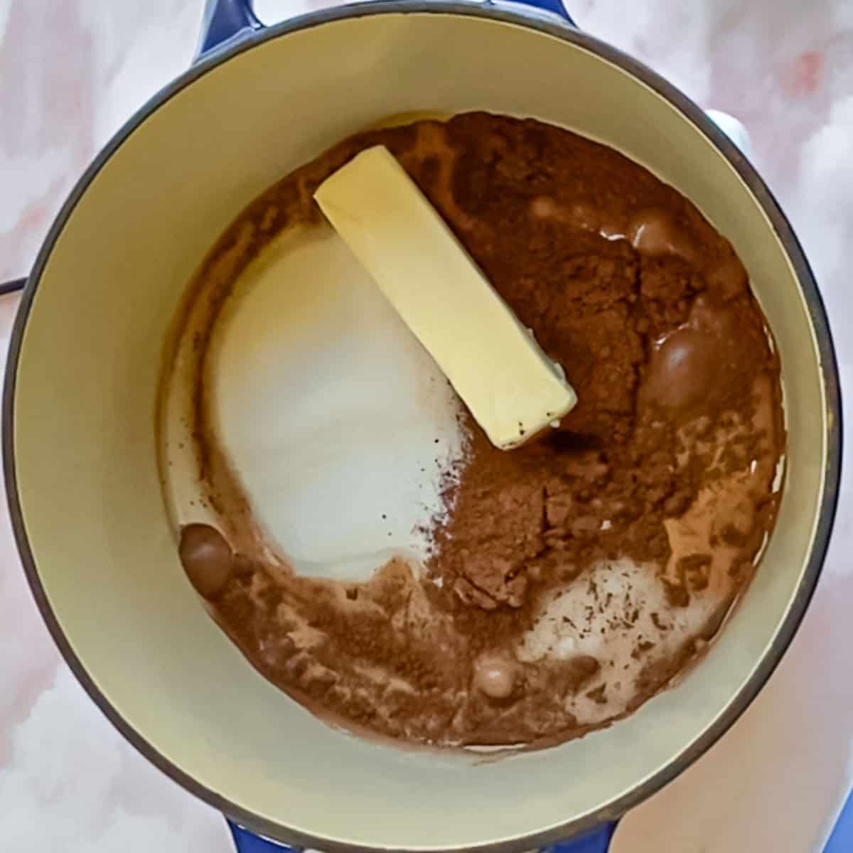butter, sugar, milk and cocoa in dutch oven