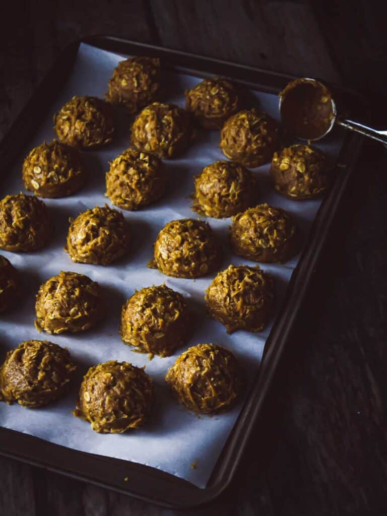 pumpkin oatmeal cookie dough balls on a baking sheet
