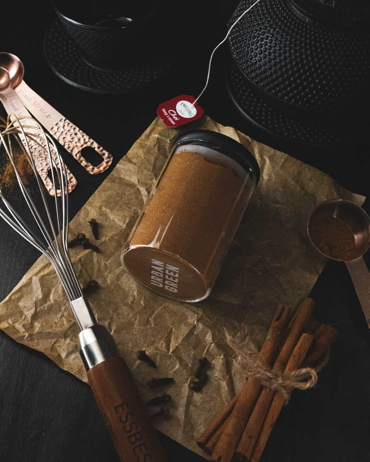 overhead of chai spice next to a whisk