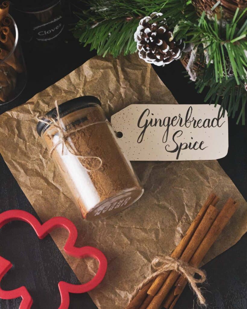 overhead of gingerbread spice next to cinnamon sticks