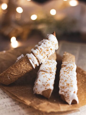 three gingerbread biscotti leaned against eachother