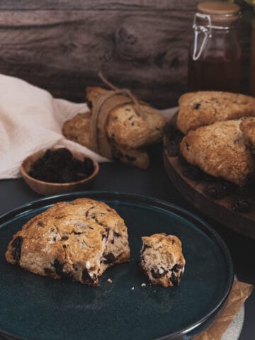 a chocolate cherry scones on a place with a bite taken out.