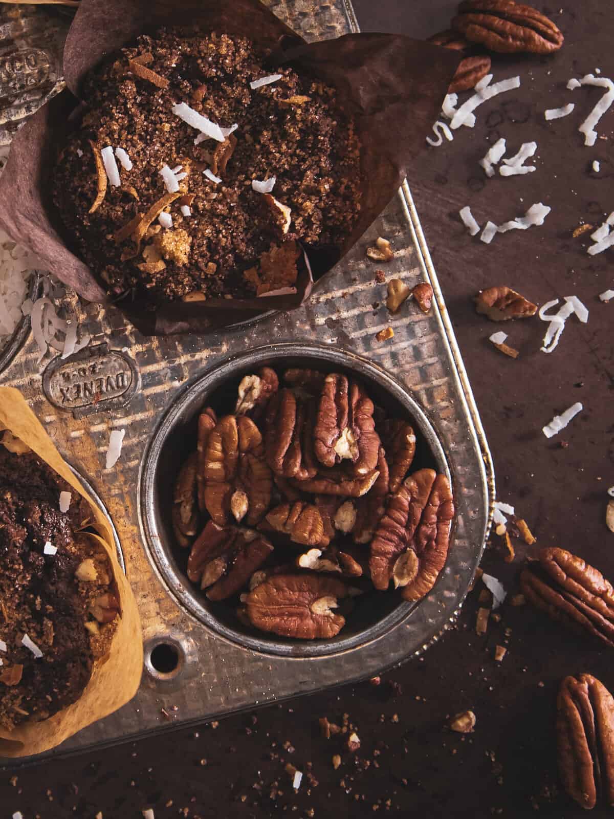 german muffins in a muffin tin with some pecans