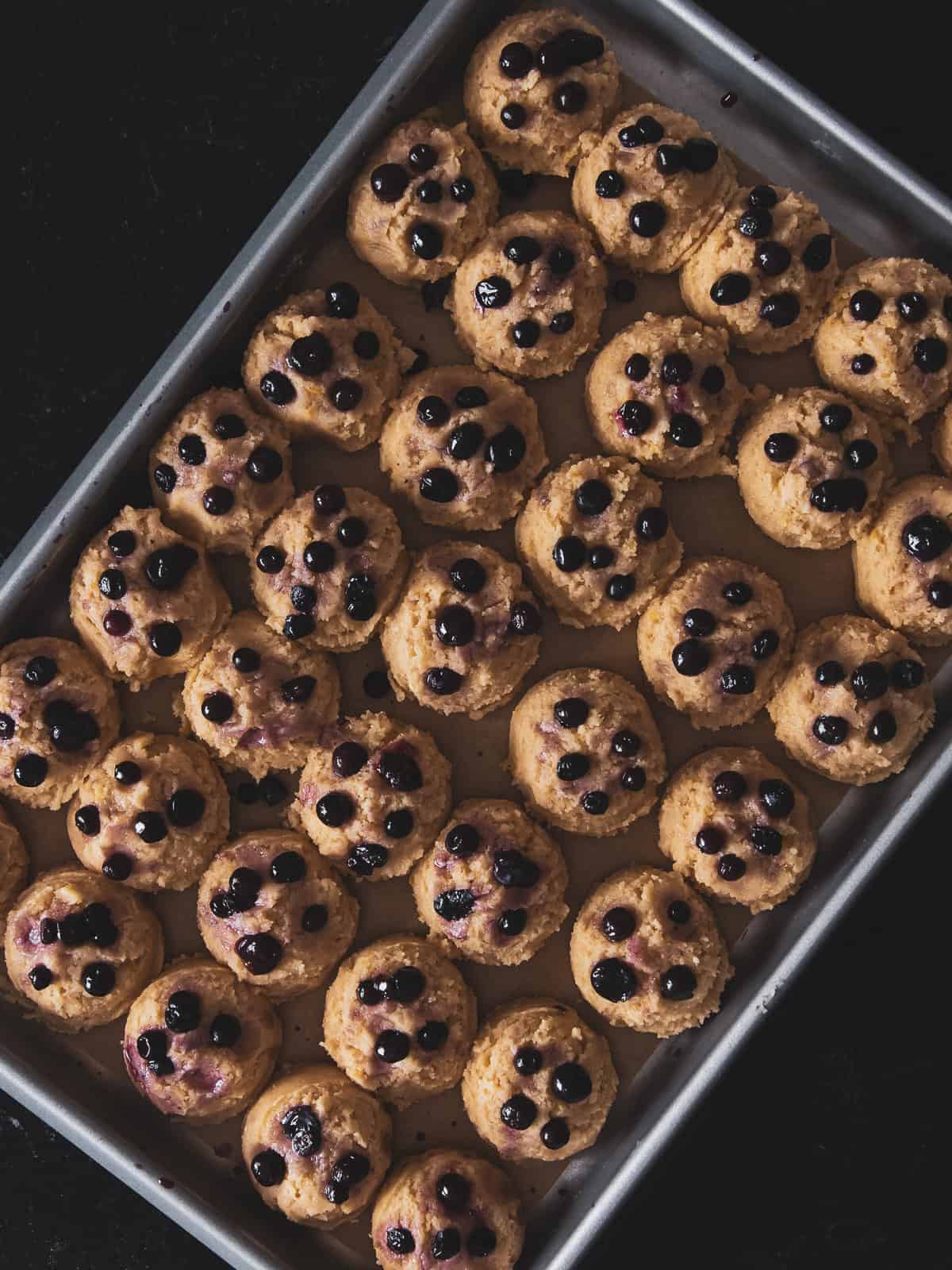 lemon blueberry cookie dough balls on a baking sheet