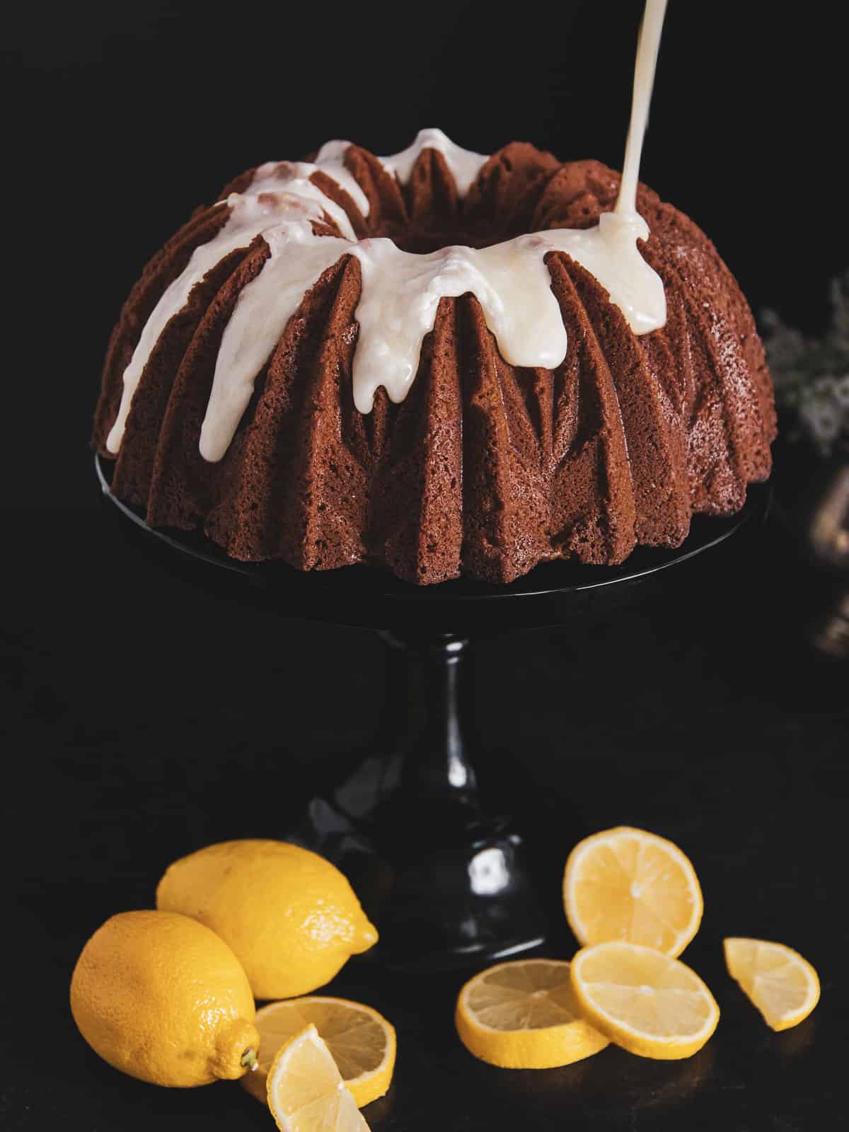 lemon curd cake with lemon glaze being poured on top