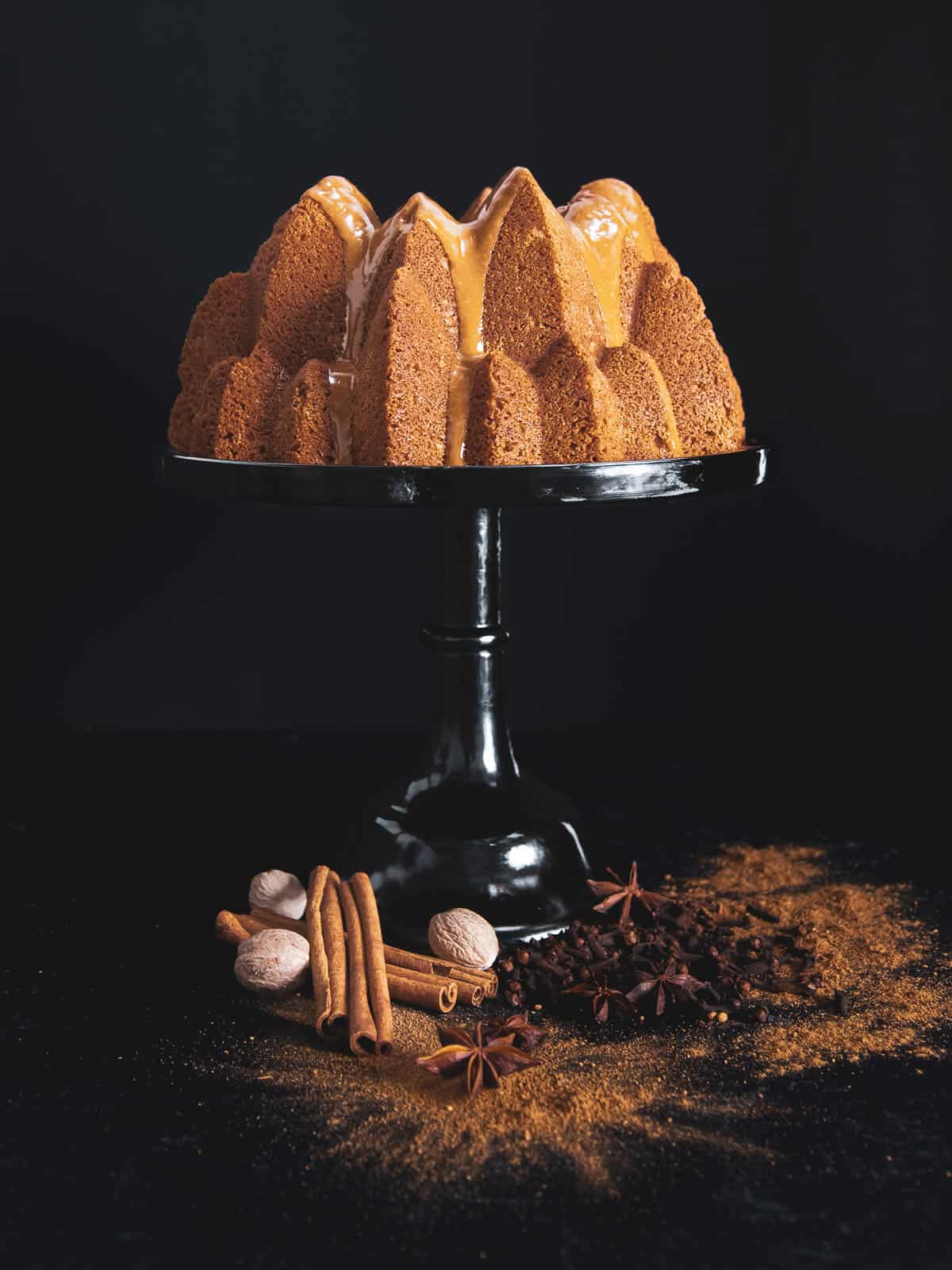chai spice cake with espresso glaze on a cake stand