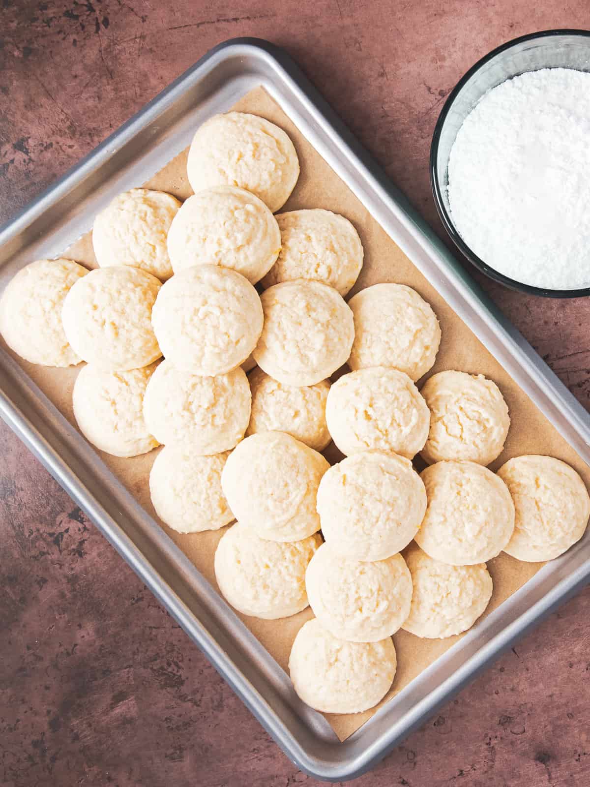 fresh baked lemon cooler cookies in a baking sheet.