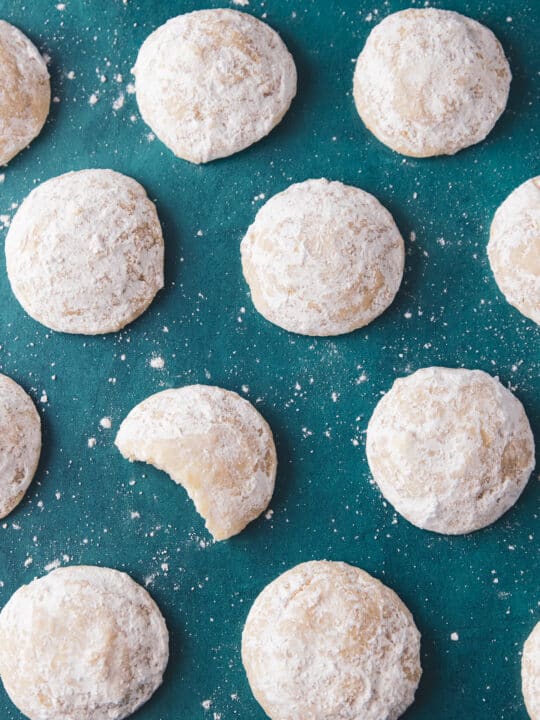 lemon cooler cookies next to each other with one having a bite taken out.
