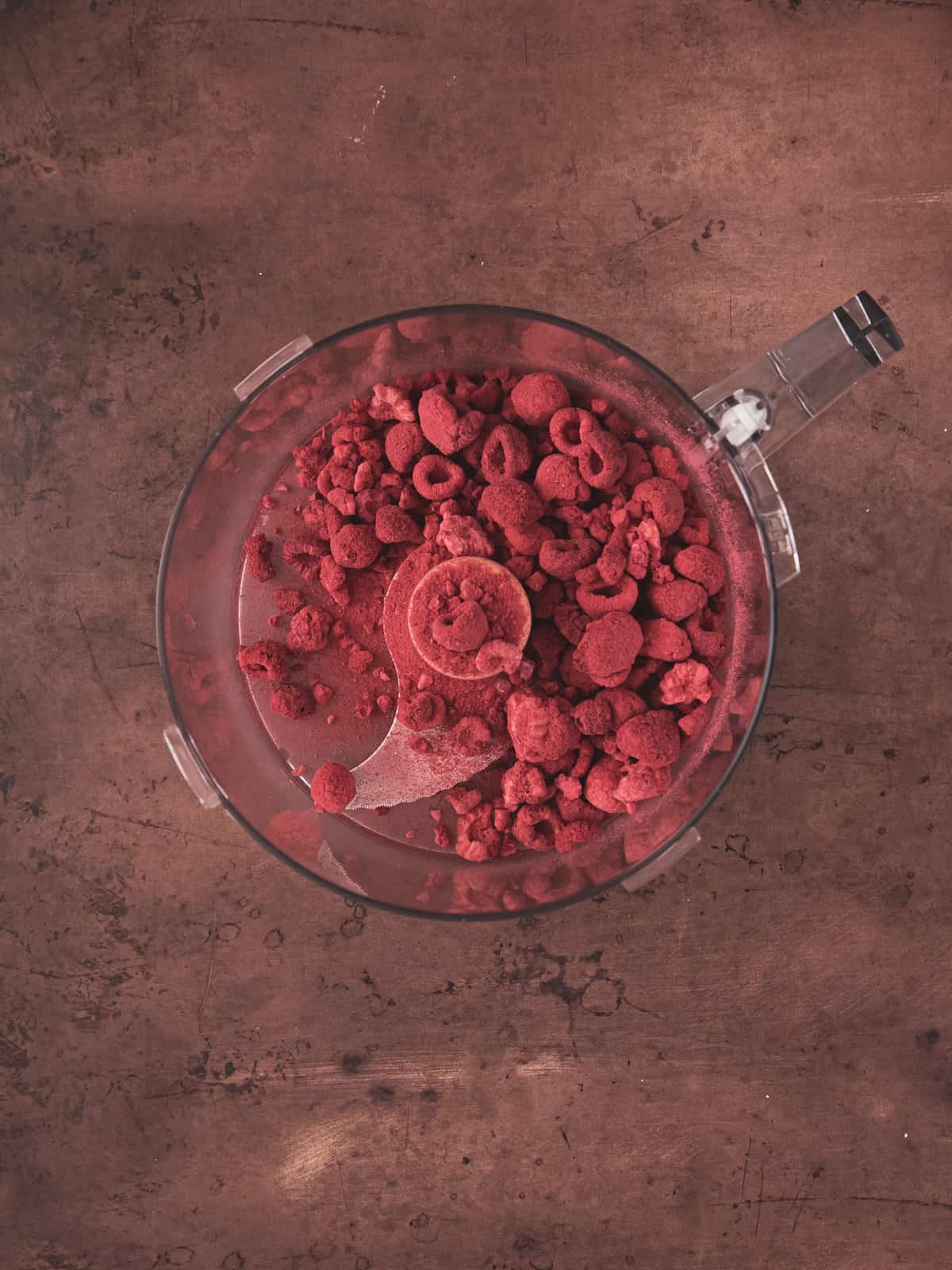 raspberries in a food processor bowl.