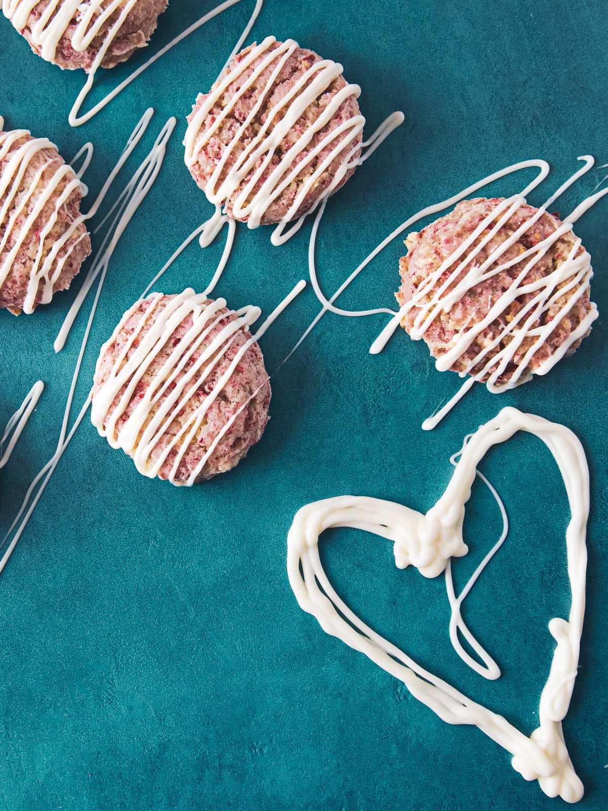 cookies drizzled in white chocolate with a heart.
