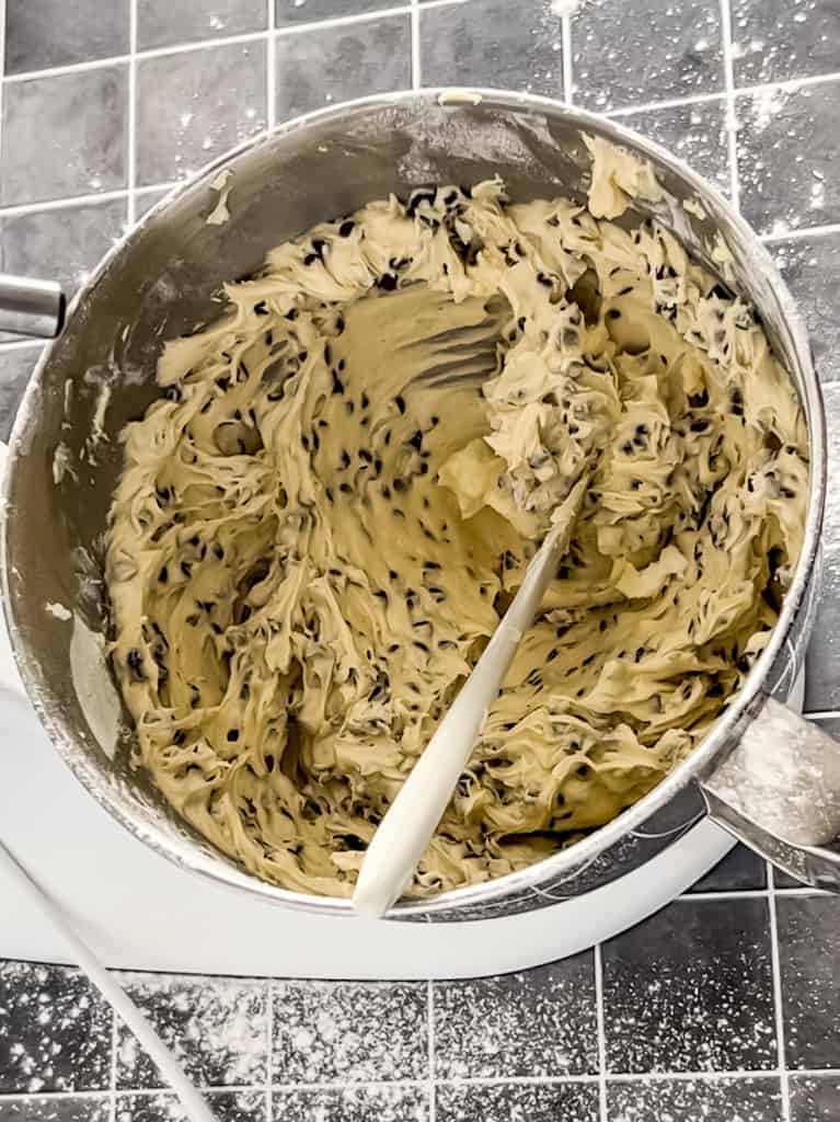 stand mixer bowl full of chocolate chip muffin batter.