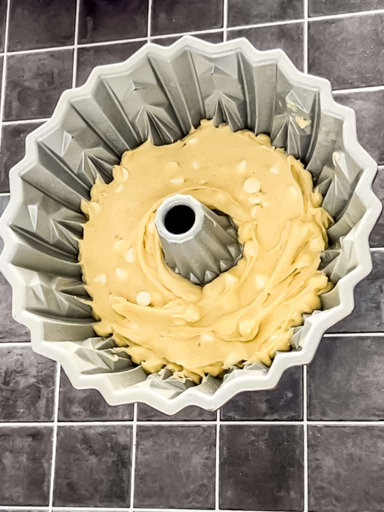 First white chocolate cake batter layer added to the bundt pan.