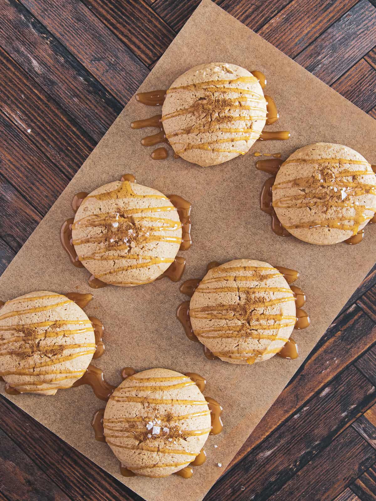 Fresh baked and decorated with caramel and flaky salt apple cider cookies.