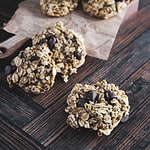 A grouping of fresh baked banana oatmeal cookies with milk chocolate chips.