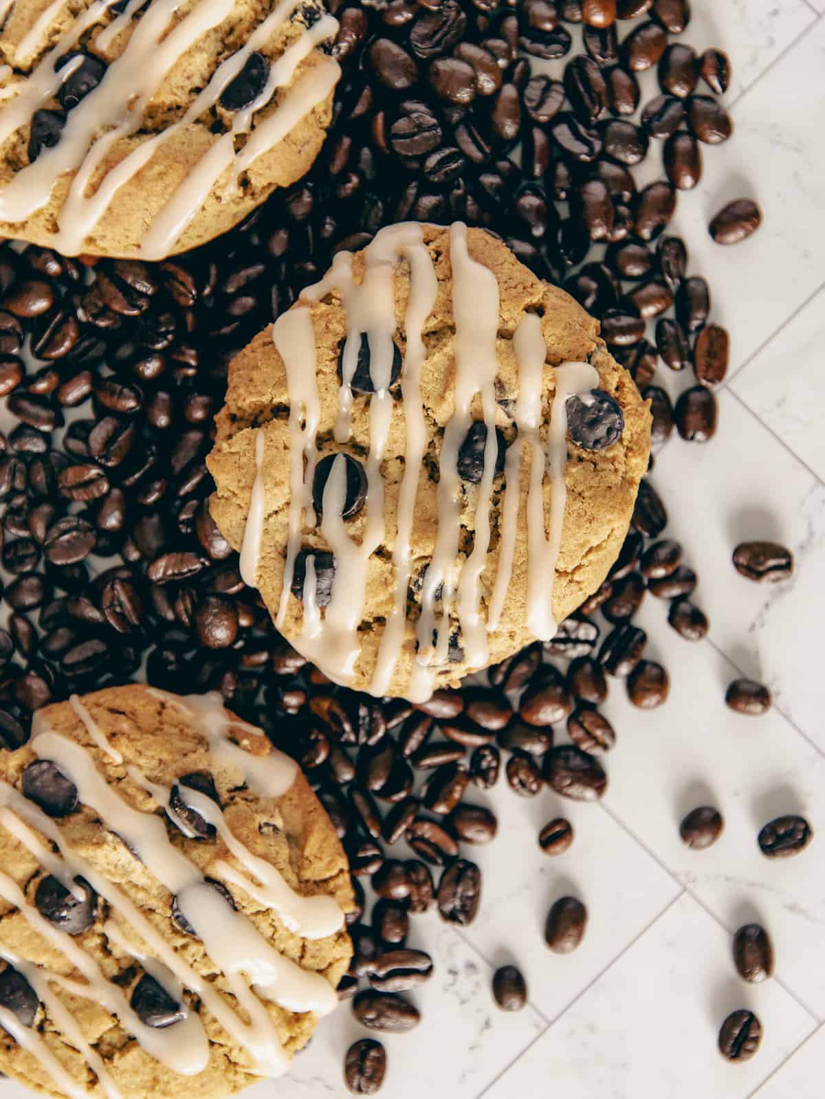 Coffee cookies surrounded by coffee beans.