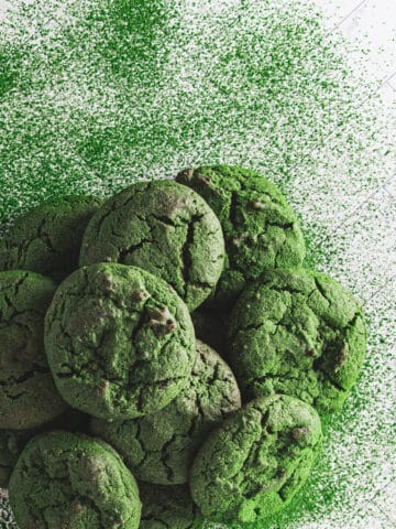 A pile of matcha cookies dusted with extra matcha powder.