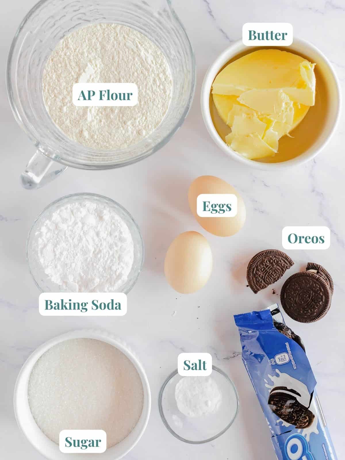 Oreo cookie ingredients and recipe on a marble countertop.