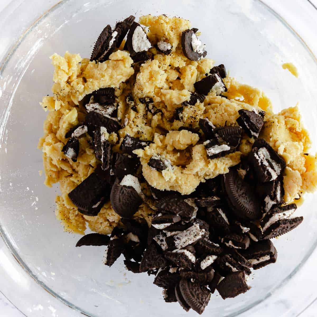 Cookies and cream cookie dough in a glass bowl.