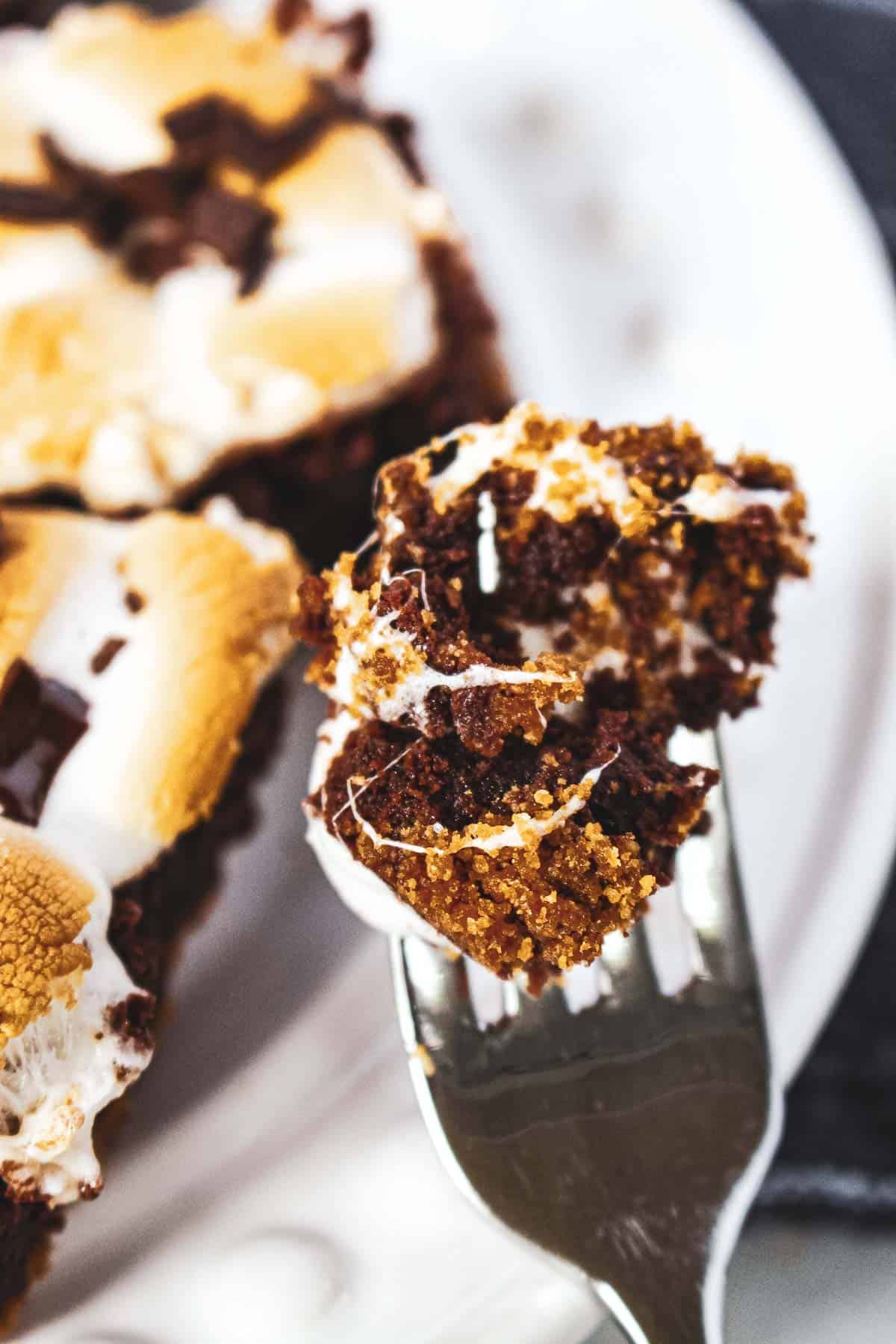 A bite on a fork of the smores brownie.